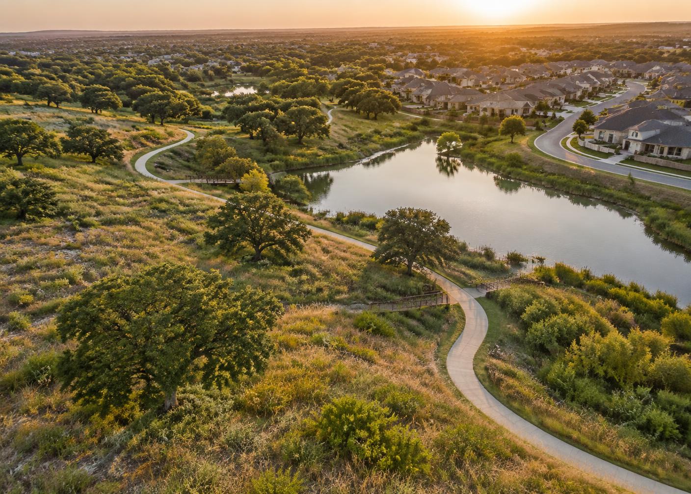 Greenbelt trail and pond in a Hutto master-planned community